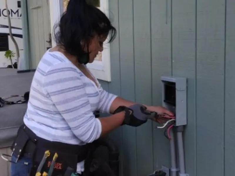 Licensed electrician wiring an exterior subpanel in Angier