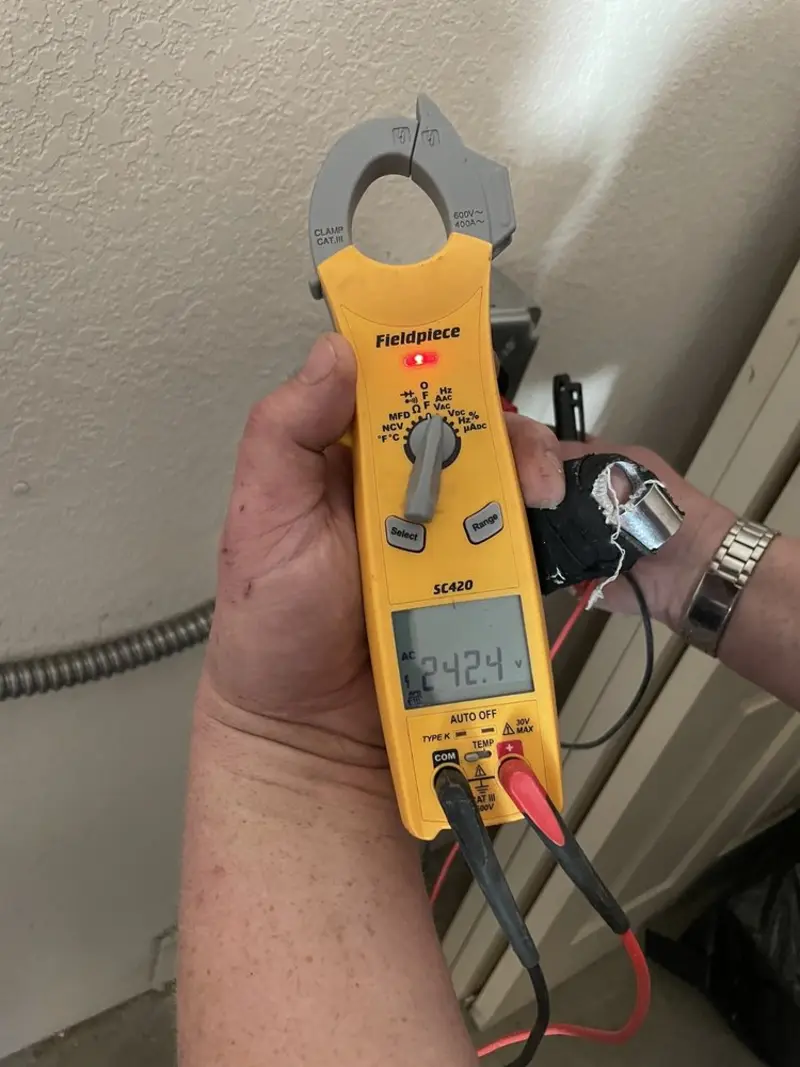 Voltage testing with clamp meter during Ceiling Fan Installation in Angier